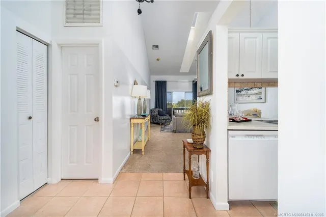 a living room with furniture a large window and a chandelier