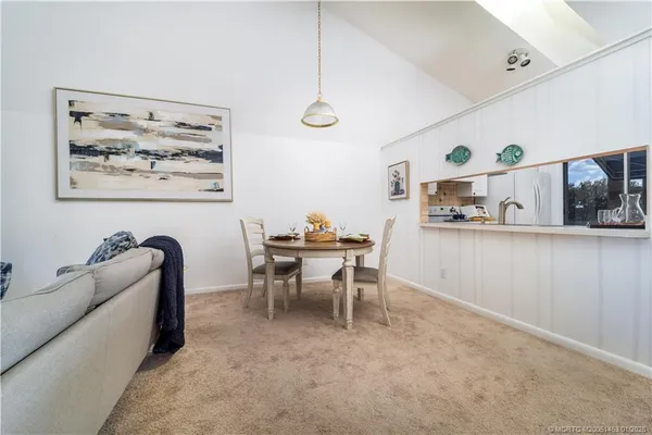 a living room with furniture a large window and a chandelier