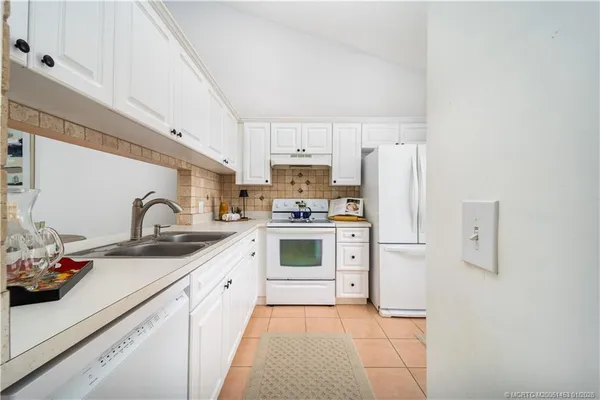 a kitchen with a stove a sink and a refrigerator