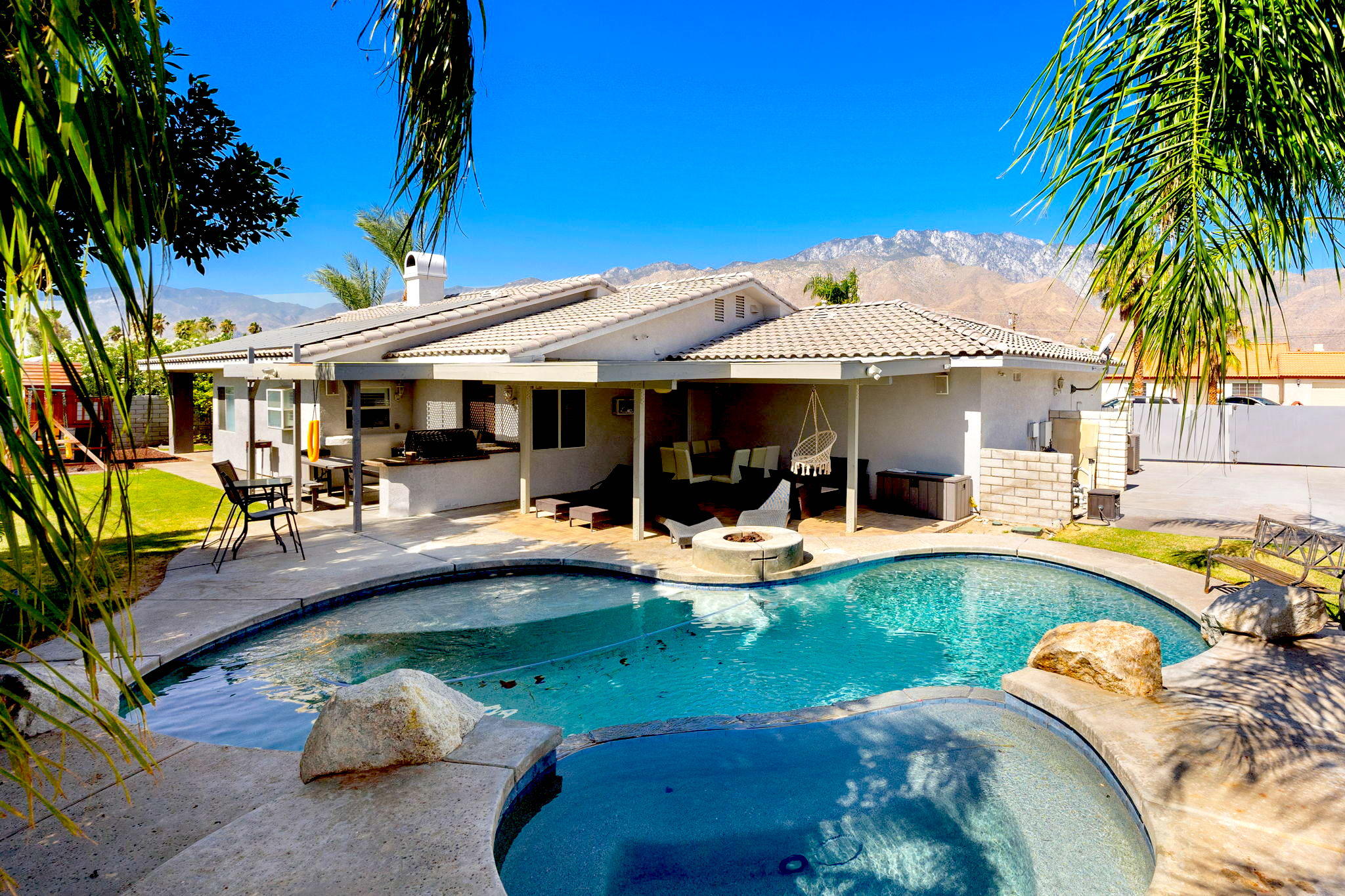 2120 West Nicola Road Palm Springs, CA 92262 - Photo 1 of 37 a view of a swimming pool with lounge chairs in patio