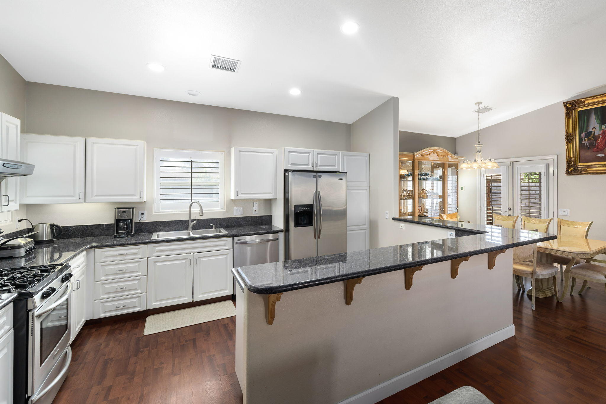2120 West Nicola Road Palm Springs, CA 92262 - Photo 13 of 37 a kitchen with stainless steel appliances granite countertop a stove a sink a refrigerator and white cabinets