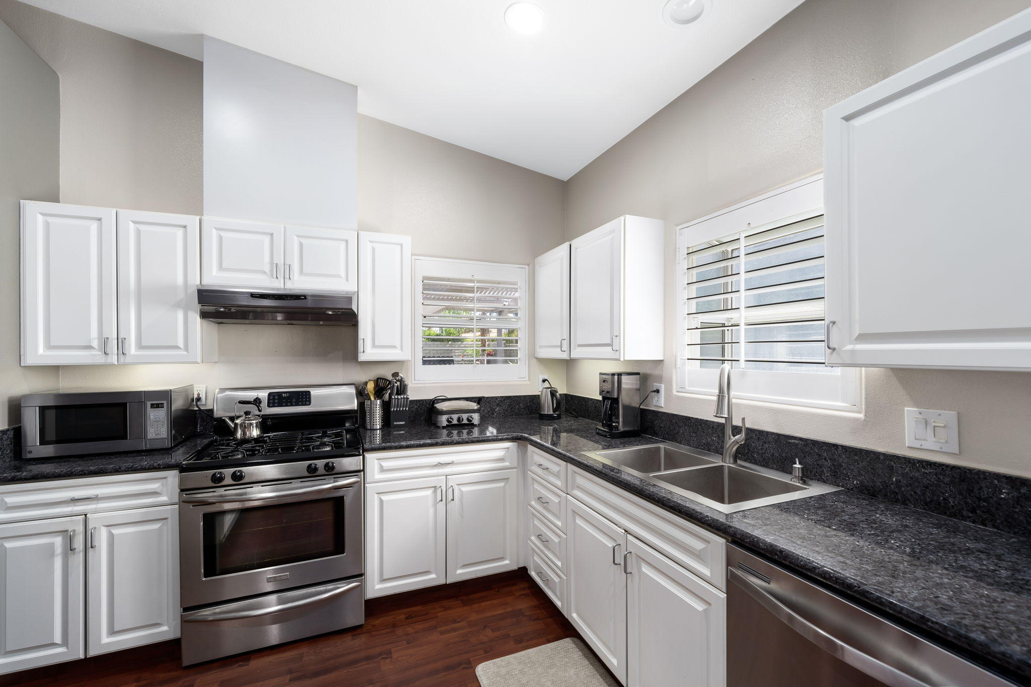 2120 West Nicola Road Palm Springs, CA 92262 - Photo 14 of 37 a kitchen with granite countertop a sink a window and cabinets