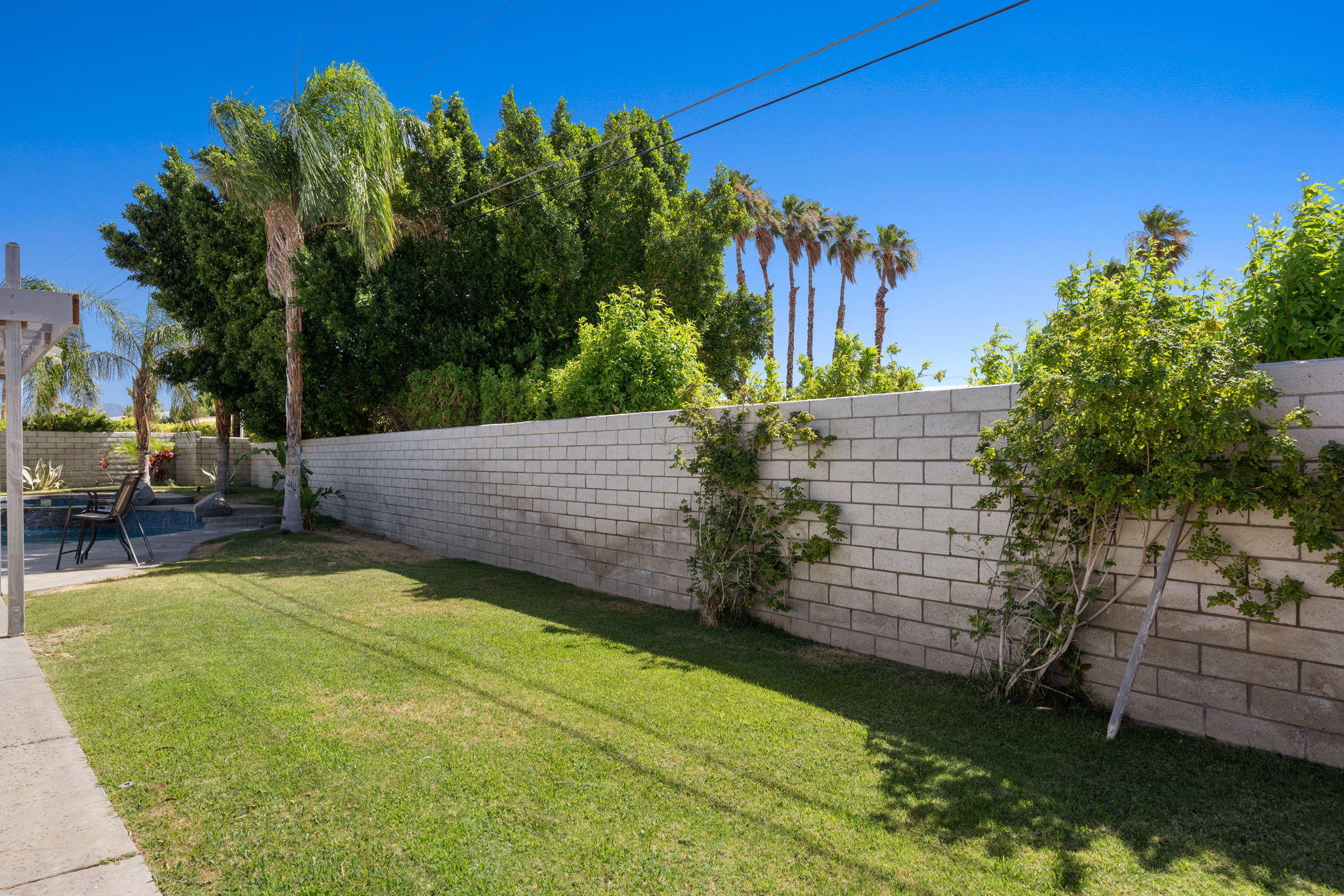 2120 West Nicola Road Palm Springs, CA 92262 - Photo 21 of 37 a view of a backyard with plants and a patio