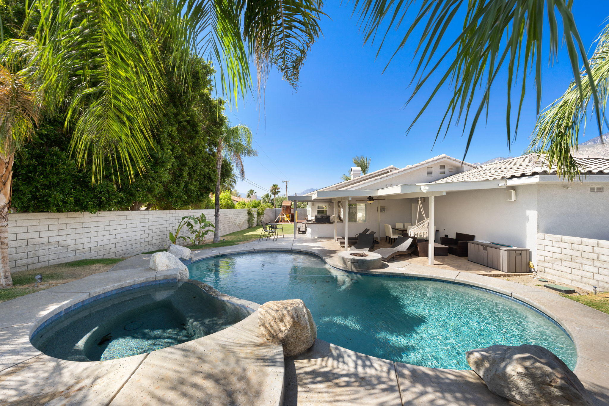 2120 West Nicola Road Palm Springs, CA 92262 - Photo 27 of 37 a view of a swimming pool with a patio and a yard