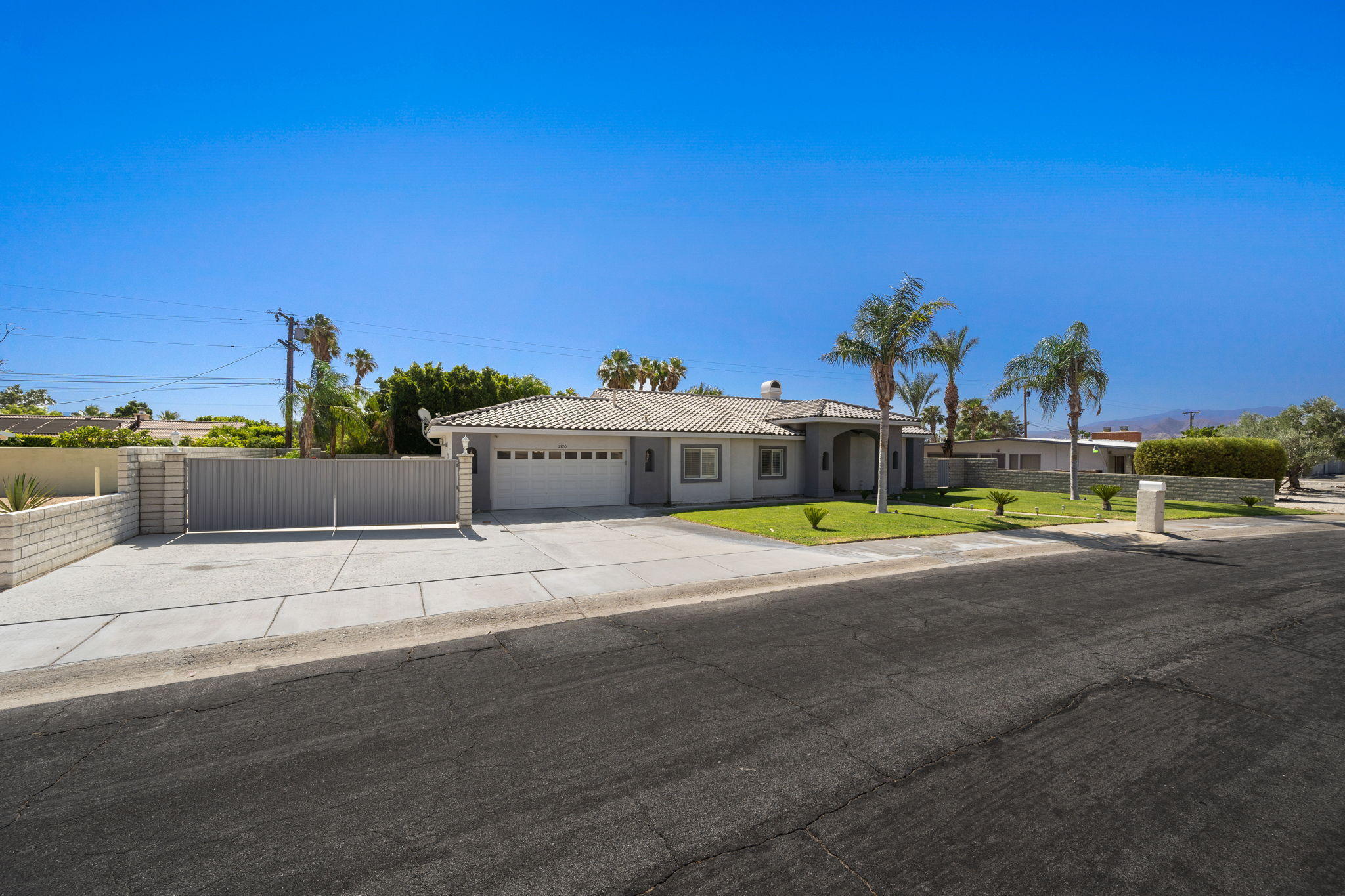 2120 West Nicola Road Palm Springs, CA 92262 - Photo 4 of 37 a view of a street with a building in the background