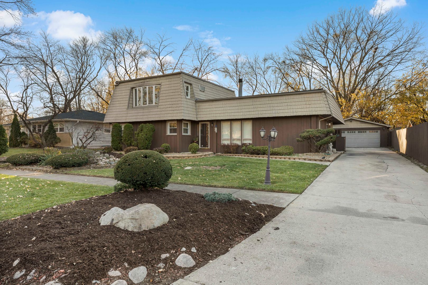 18740 Springfield Avenue Flossmoor, IL 60422 - Photo 1 of 16 a view of a big house with a big yard and potted plants