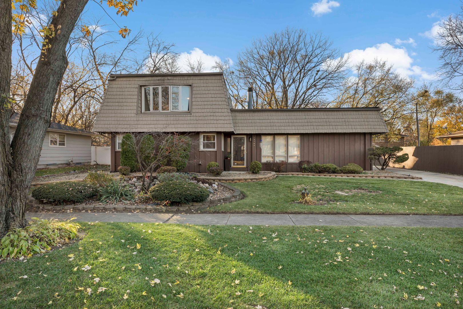18740 Springfield Avenue Flossmoor, IL 60422 - Photo 2 of 16 a front view of a house with a garden