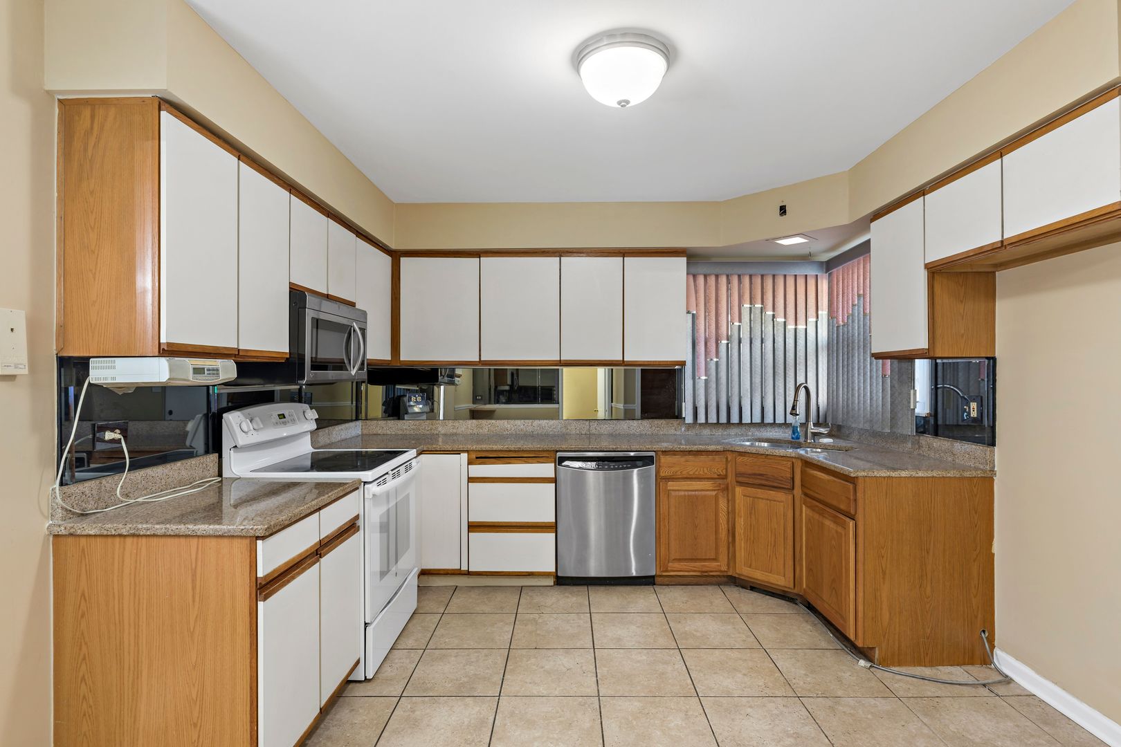 18740 Springfield Avenue Flossmoor, IL 60422 - Photo 8 of 16 a kitchen with stainless steel appliances granite countertop a sink counter space cabinets and a large window