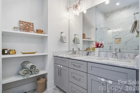 a bathroom with a granite countertop sink a mirror and vanity