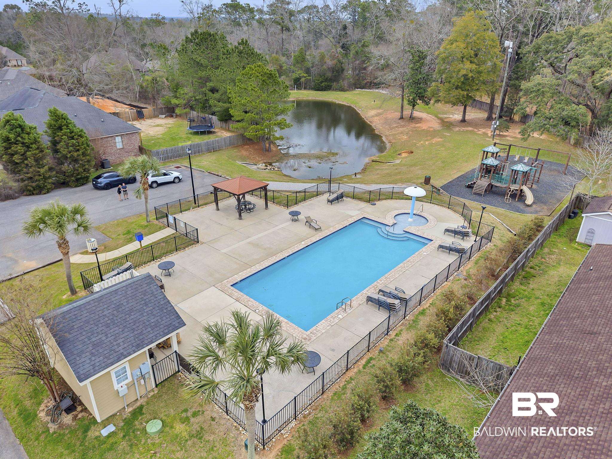 11247 Thistledown Loop Spanish Fort, AL 36527 - Photo 56 of 72 Pool featuring a water view, fence, an outdoor structure, and a patio