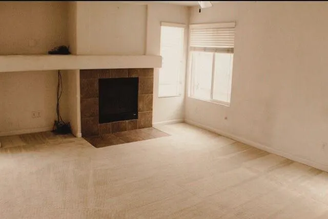 a view of an empty room with a fireplace