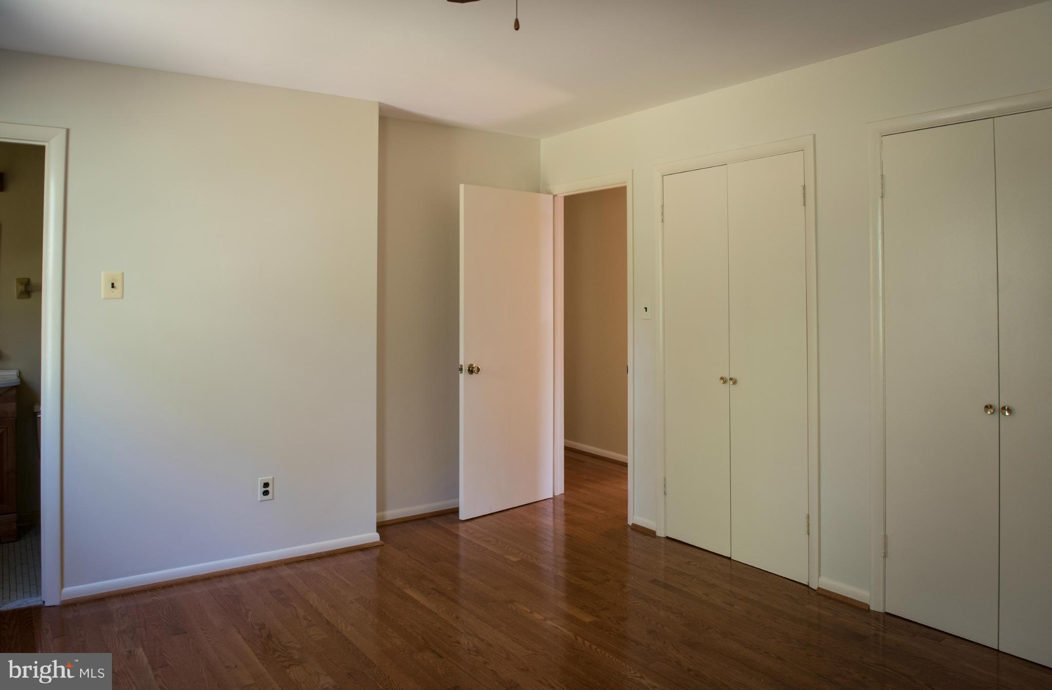 3213 Llewellyn Field Road Olney, MD 20832 - Photo 23 of 30 a view of an empty room with wooden floor
