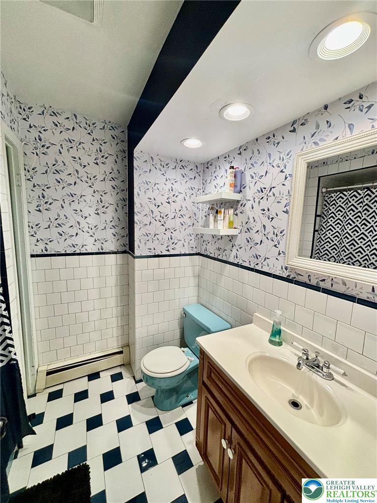 8813 Bluejay Road Kempton, PA 19529 - Photo 14 of 23 This bright bathroom features a unique tile floor and modern fixtures, creating a refreshing atmosphere.