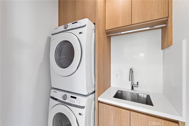 a kitchen with a sink and a washer dryer