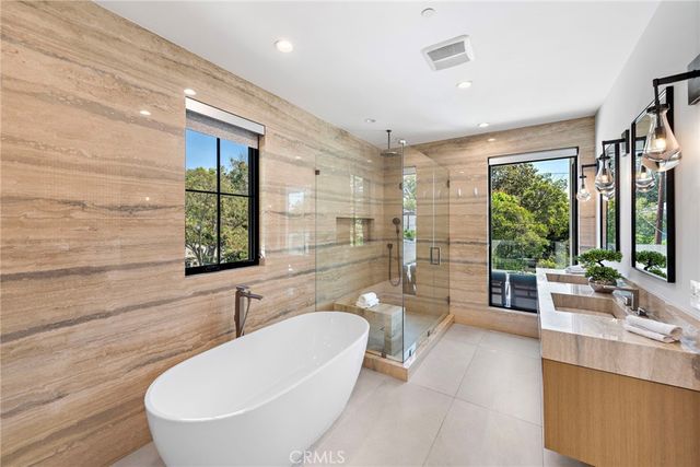 a bathroom with a granite countertop sink a large mirror and shower