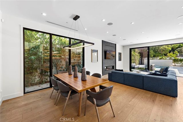 a dining room with wooden floor and furniture