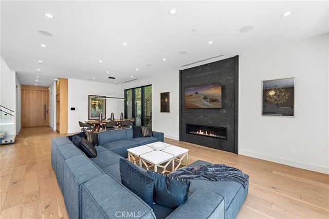 a living room with furniture flat screen tv and a fireplace