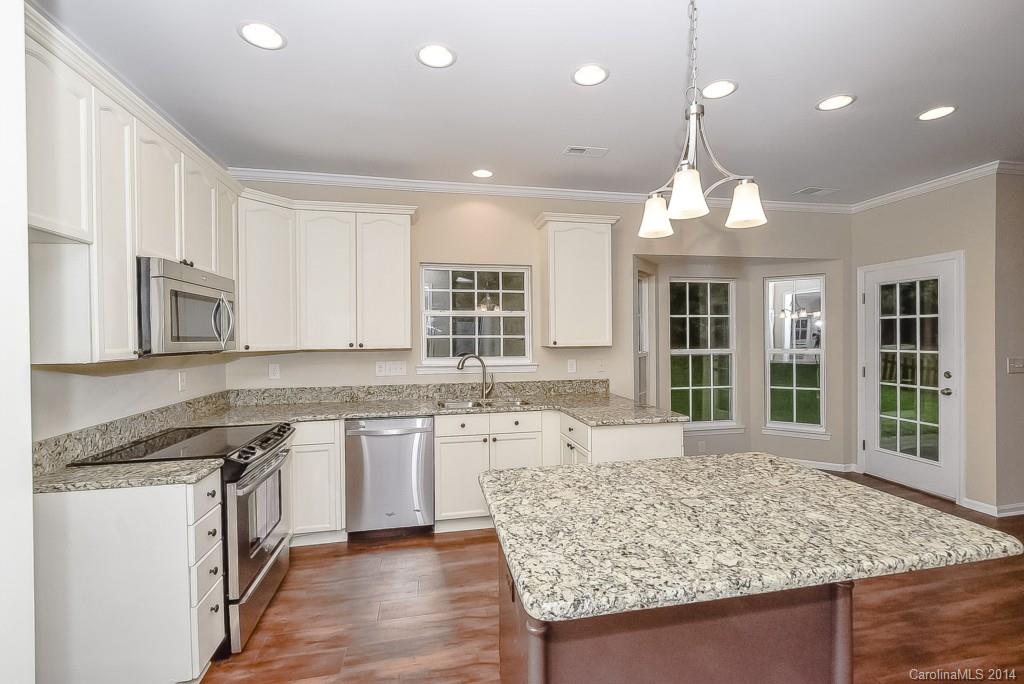 709 Warwick Way Fort Mill, SC 29708 - Photo 13 of 24 a large kitchen with granite countertop a stove and a sink