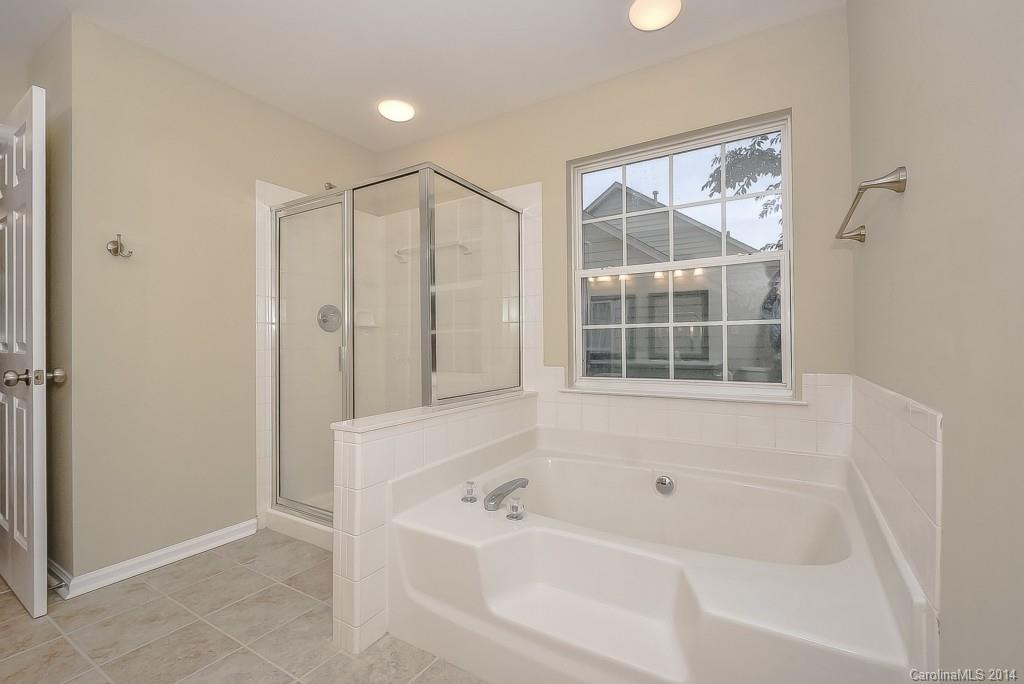 709 Warwick Way Fort Mill, SC 29708 - Photo 19 of 24 a bathroom with a bathtub and a shower