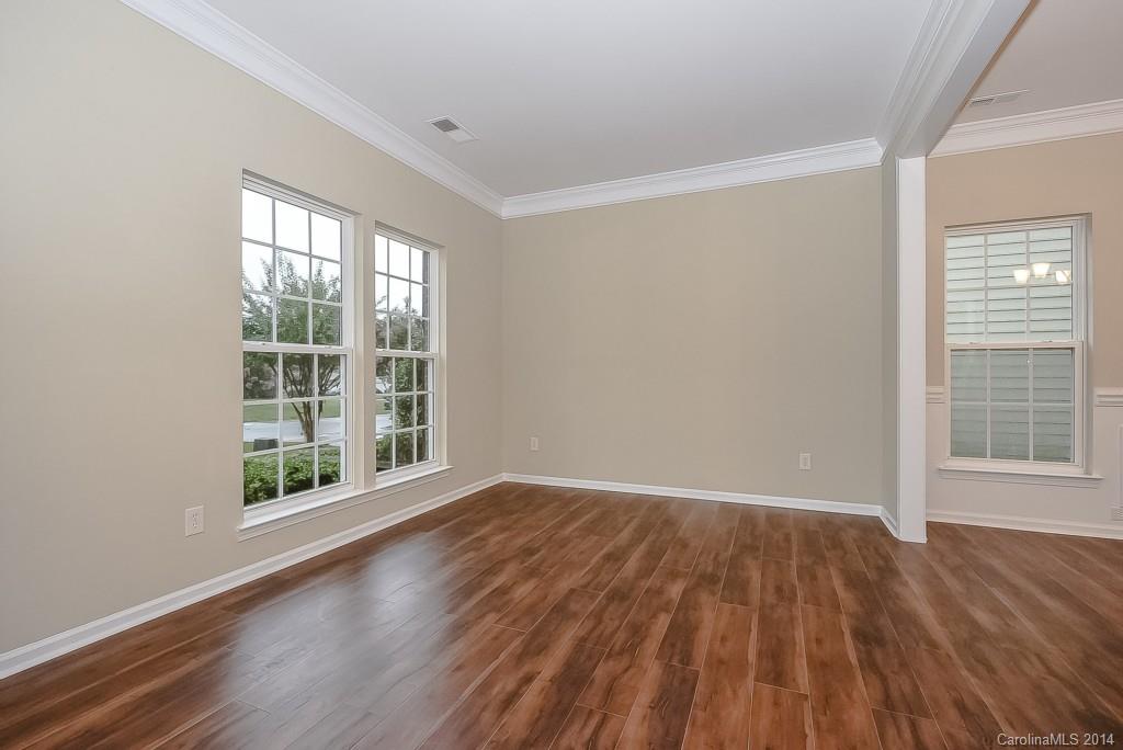 709 Warwick Way Fort Mill, SC 29708 - Photo 3 of 24 a view of an empty room with wooden floor and a window