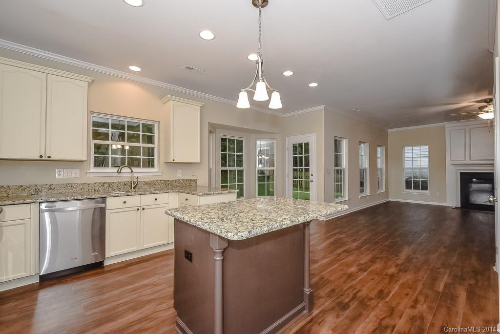 709 Warwick Way Fort Mill, SC 29708 - Photo 7 of 24 a open kitchen with granite countertop kitchen island a sink appliances and a counter space