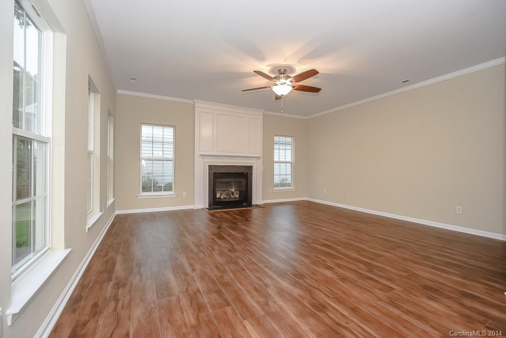 709 Warwick Way Fort Mill, SC 29708 - Photo 8 of 24 a view of empty room with wooden floor and fan