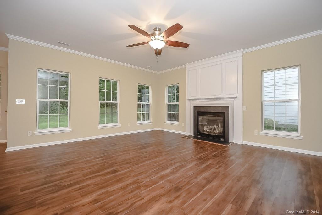 709 Warwick Way Fort Mill, SC 29708 - Photo 9 of 24 a view of an empty room with wooden floor and a window