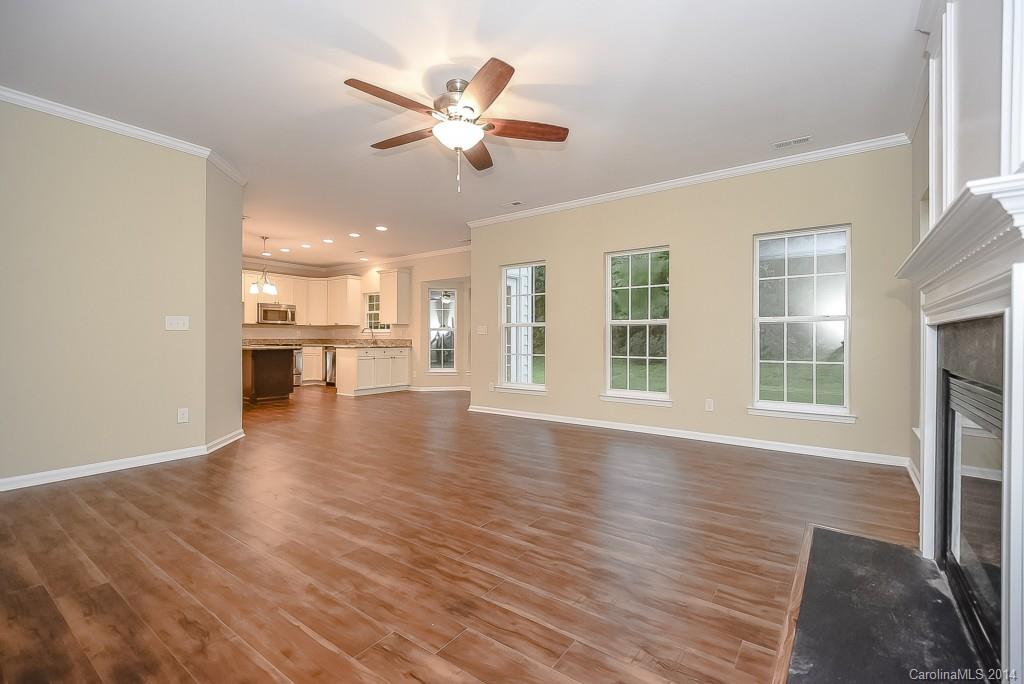 709 Warwick Way Fort Mill, SC 29708 - Photo 10 of 24 a view of an empty room with wooden floor and a window