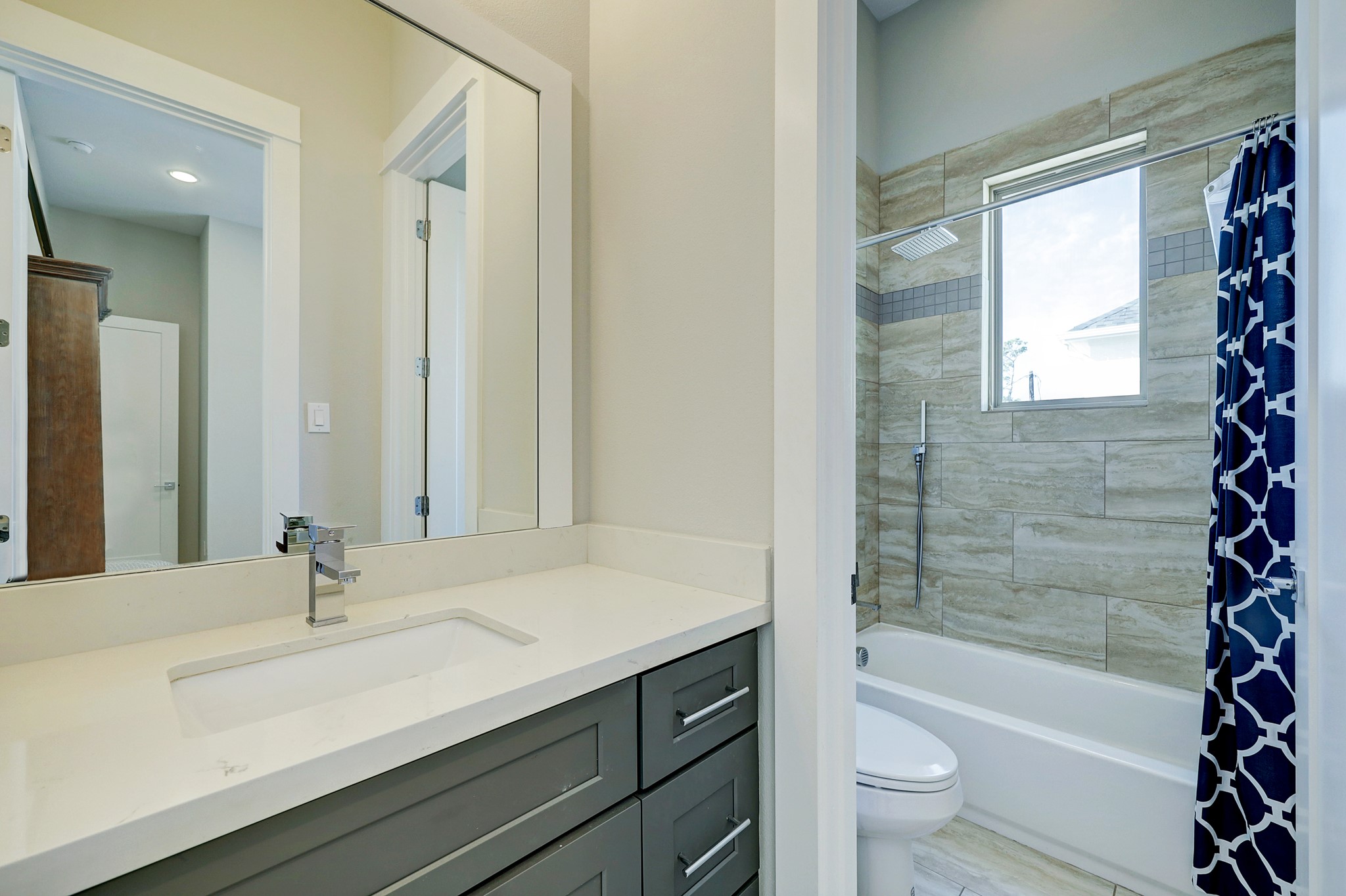 806 Thornton Road, Unit A Houston, TX 77018 - Photo 8 of 15 a bathroom with a bathtub shower sink vanity mirror and toilet