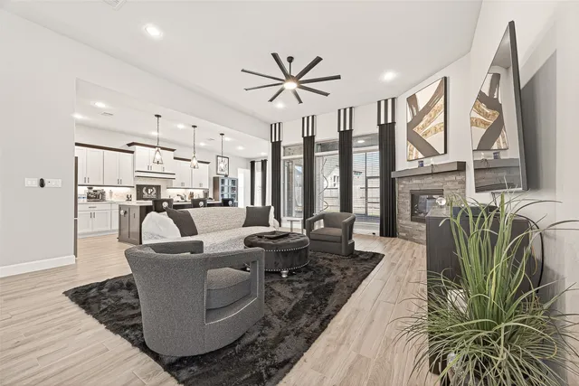a living room with furniture large window and flat screen tv