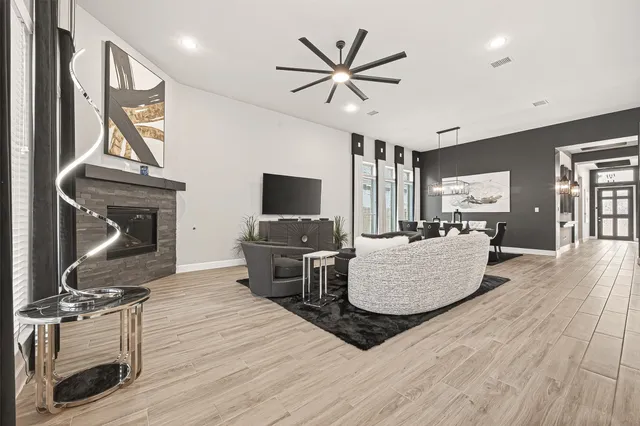 a living room with furniture a fireplace and a flat screen tv