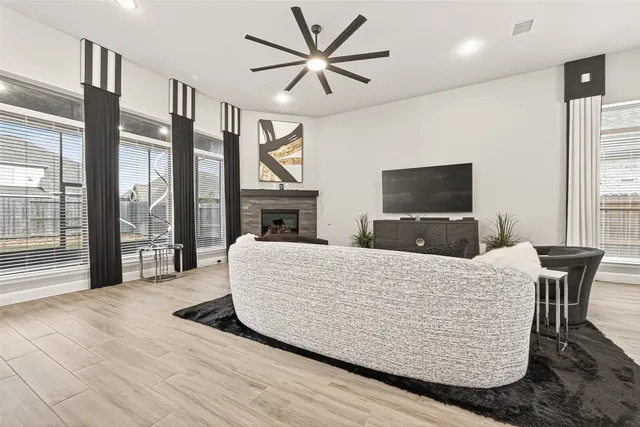 a living room with furniture a fireplace and a flat screen tv