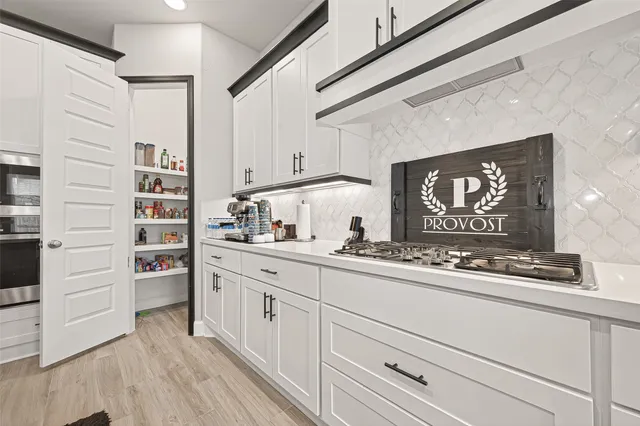 a kitchen with cabinets and window