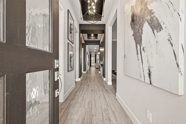 a view of hallway with wooden floor and stairs