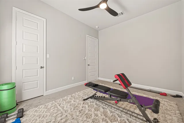 a bedroom with a bed and a wooden floor