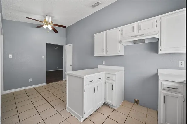 a view of kitchen with white cabinets