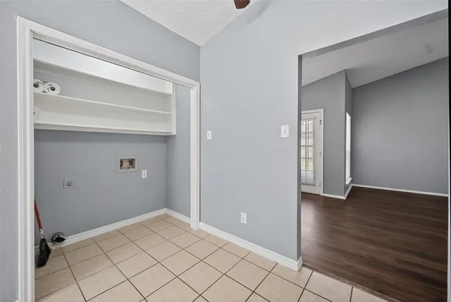 a view of an empty room and wooden floor