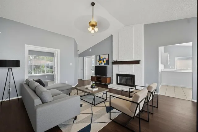 a living room with furniture a fireplace and a flat screen tv