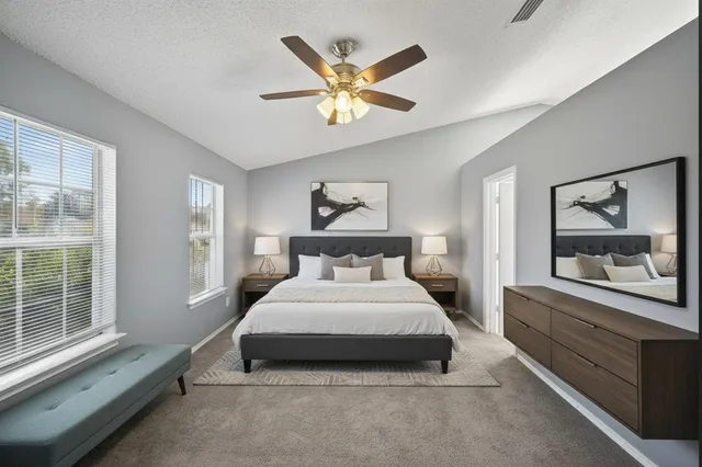 a bedroom with a large bed and a large window