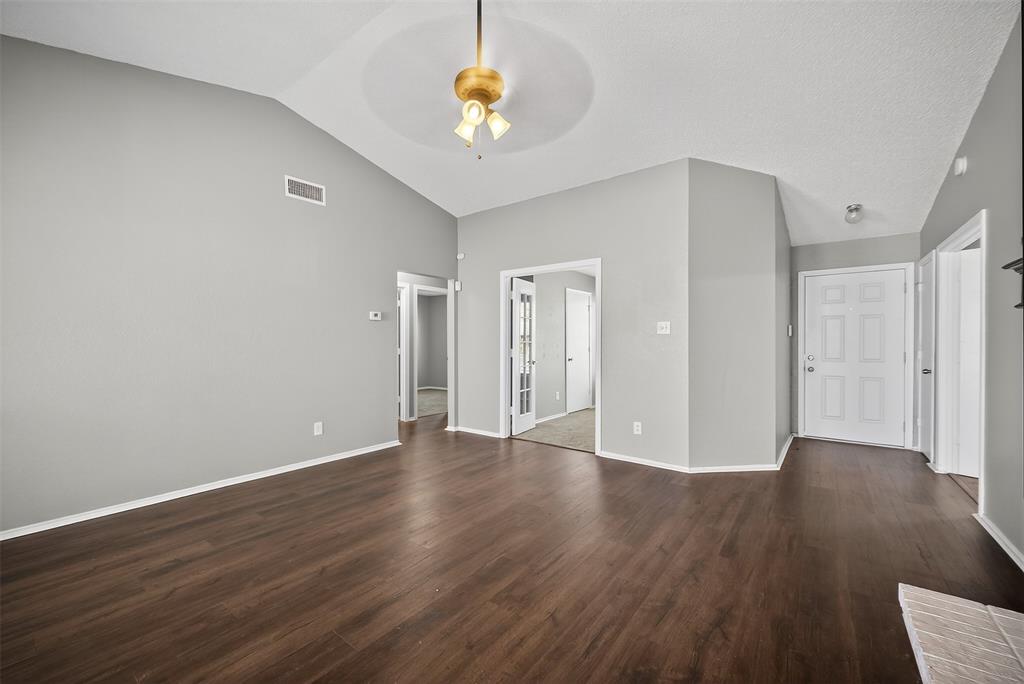 4407 Lashley Drive Dallas, TX 75232 - Photo 9 of 39 a view of an empty room with wooden floor and a window