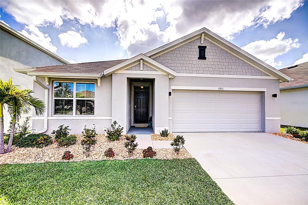 13911 Smiling Daisy Place Riverview, FL 33579 - Photo 1 of 1 a front view of a house with a yard and garage