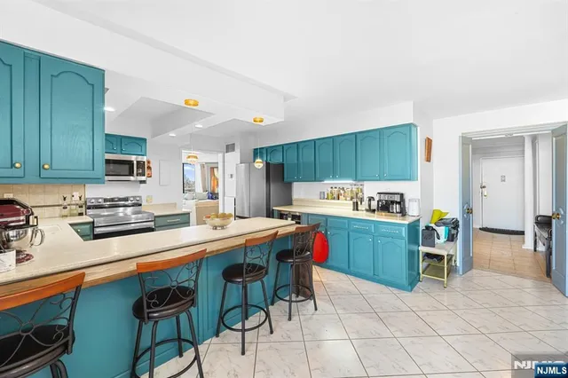 a kitchen with a table chairs and a refrigerator