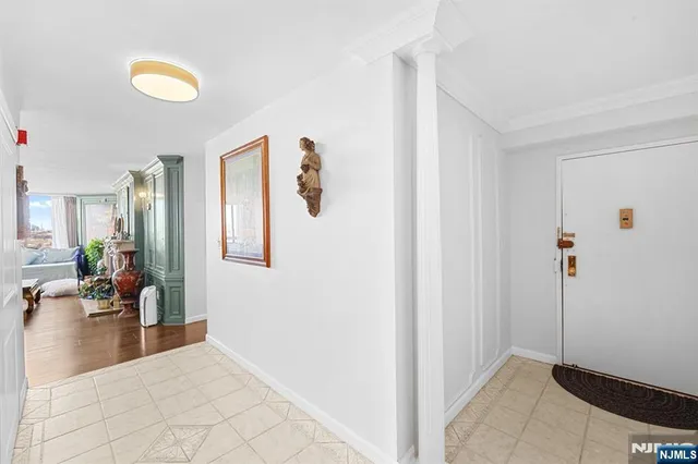 a view of a hallway with a couch and a painting on the wall