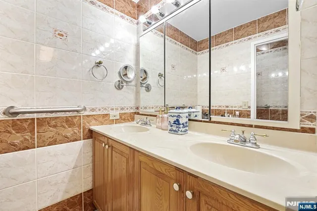 a bathroom with a sink mirror vanity and toilet