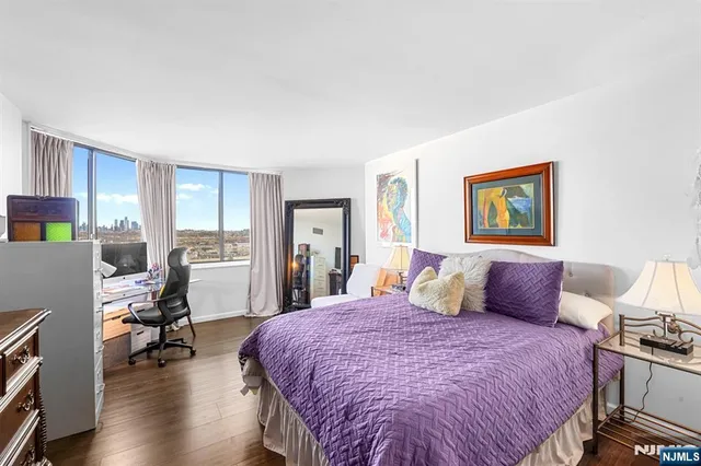 a bedroom with a bed and a painting on the wall