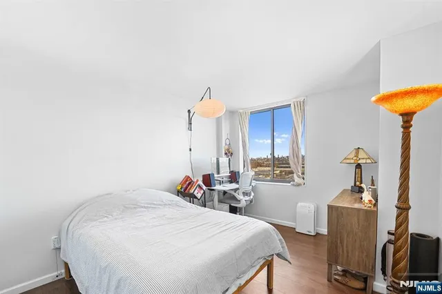 a view of a hallway with wooden floor and entryway