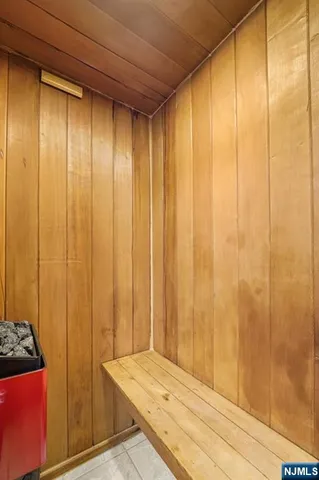 a front view of a building with glass windows and a yard