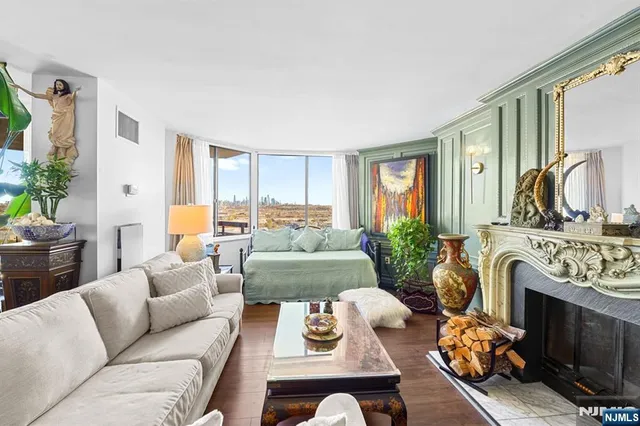 a living room with furniture fireplace and a large window