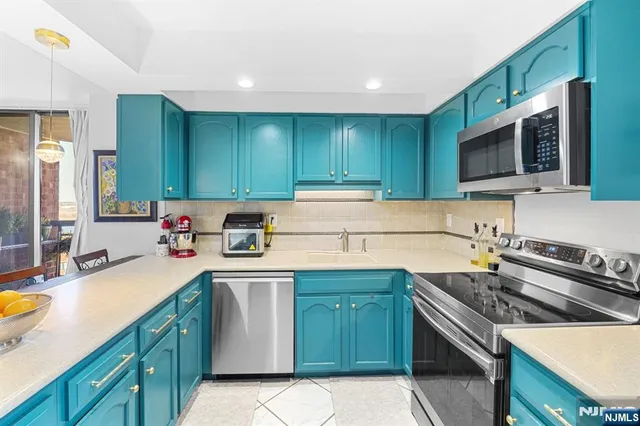 a kitchen with a sink stove top oven and cabinets