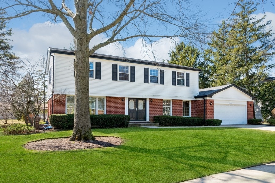 2961 Cherry Lane Northbrook, IL 60062 - Photo 2 of 21 a front view of a house with a yard and trees